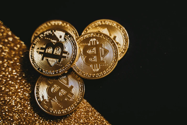 three bitcoins sitting on top of a gold cloth, by Julia Pishtar, trending on pexels, with a black background, background image, instagram post, brown