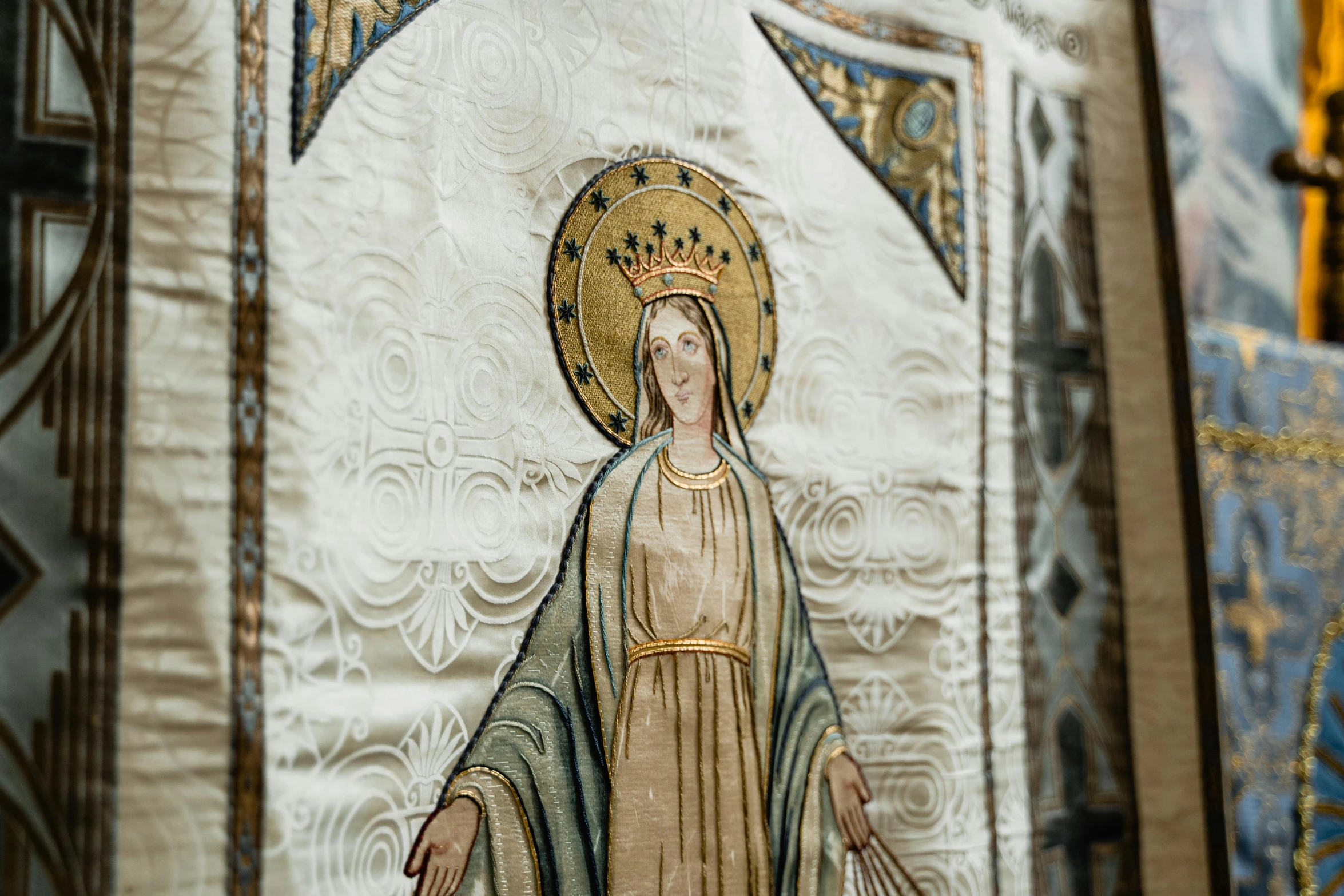 a close up of a painting on a wall, by Carey Morris, trending on unsplash, arts and crafts movement, virgin mary, victorian textiles, standing in front of the altar, charts