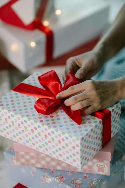 a person putting a red ribbon on a stack of presents, melbourne, profile image, petite, small