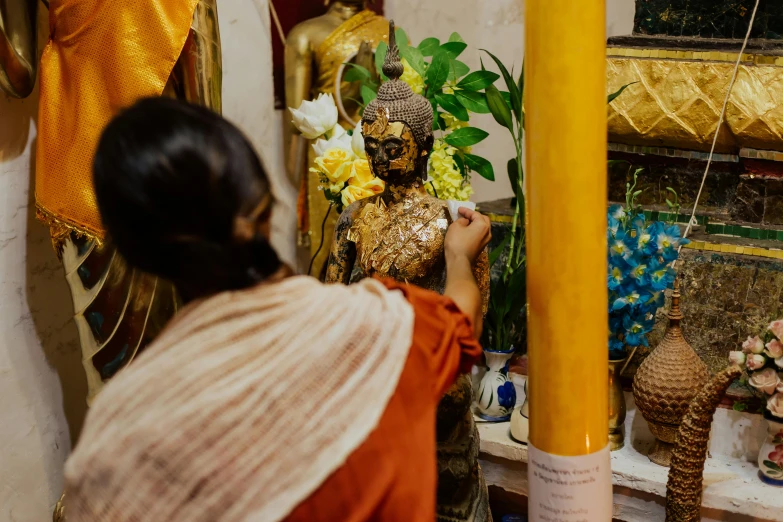 a woman that is standing in front of a statue, pexels contest winner, process art, holy ceremony, carefully crafted, inside her temple, 🦩🪐🐞👩🏻🦳