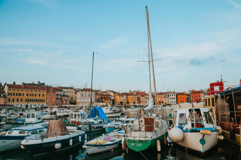 a harbor filled with lots of boats under a blue sky, by Emma Andijewska, pexels contest winner, alessio albi, style of wes anderson, square, a cozy