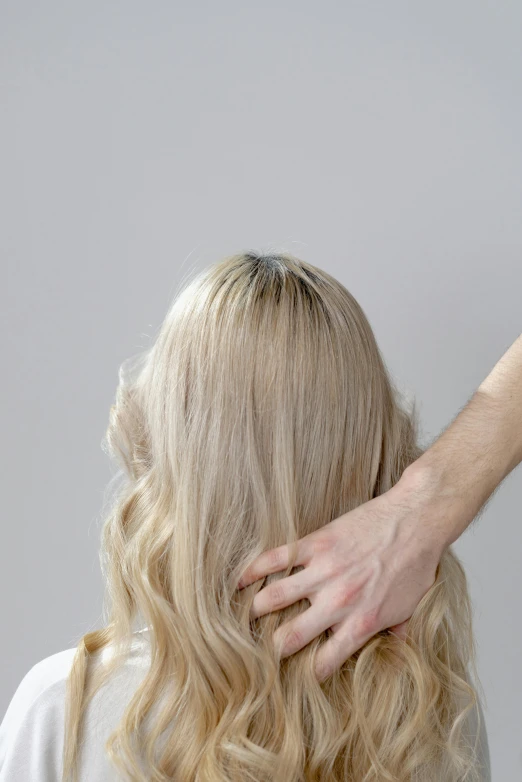 a woman getting her hair styled by a hair stylist, by James Morris, trending on unsplash, renaissance, shoulder - length blonde hair, on grey background, spine, swollen muscles