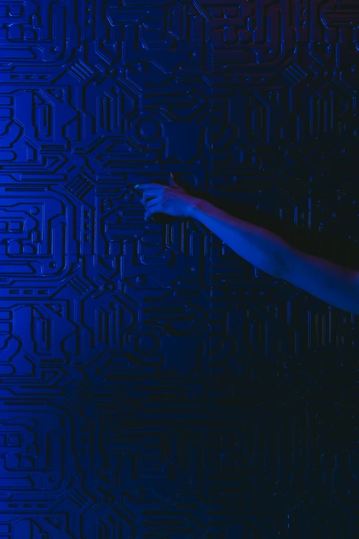 a woman standing in front of a blue wall, inspired by Yves Klein, pexels contest winner, interactive art, covered in circuitry, crawling out of a dark room, texture electronic circuit, movie still from the matrix