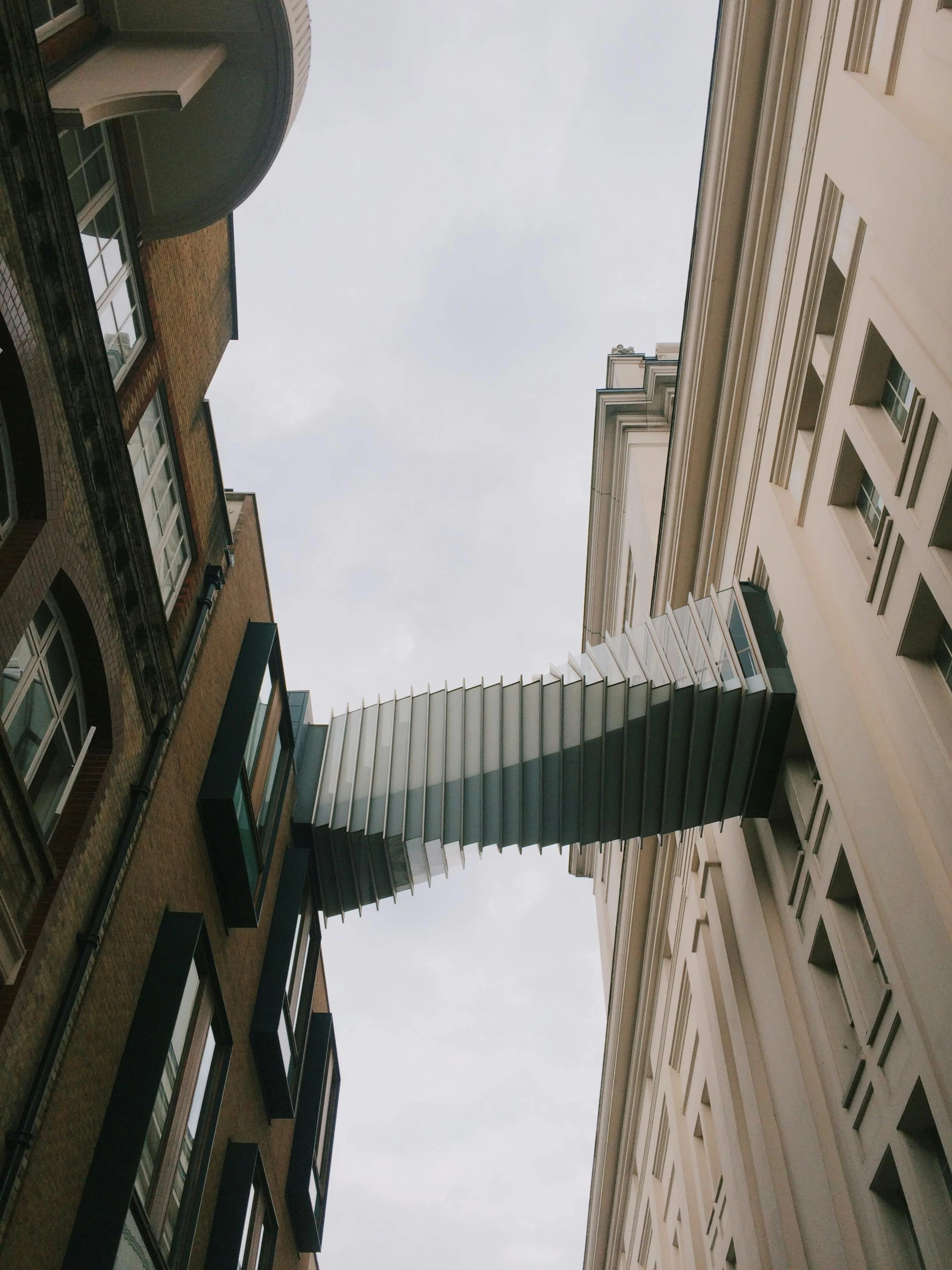 a couple of buildings that are next to each other, by Adam Rex, unsplash contest winner, kinetic art, narrow passage, london, low quality photo, suspended in air