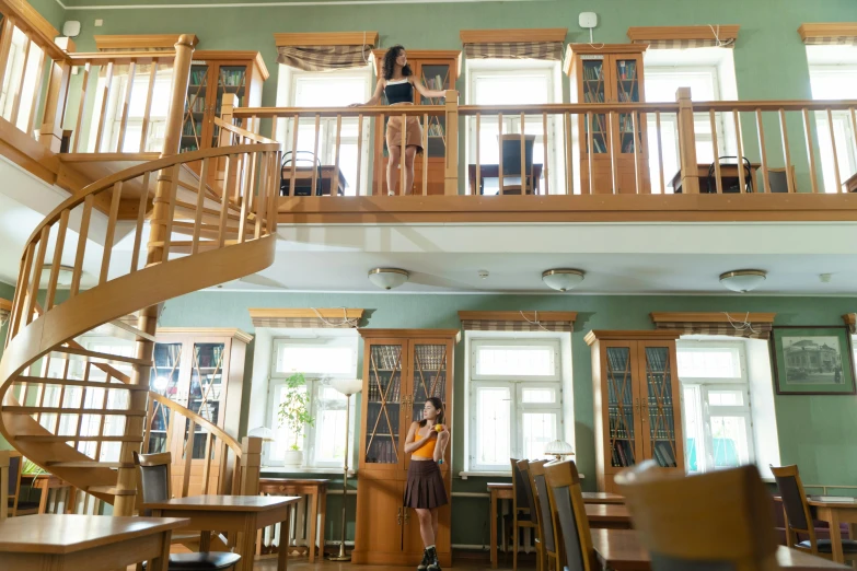 a couple of people that are standing in a room, by Maksimilijan Vanka, shutterstock, danube school, stairs and bookshelves, biodiversity heritage library, photo of a classroom, two stories