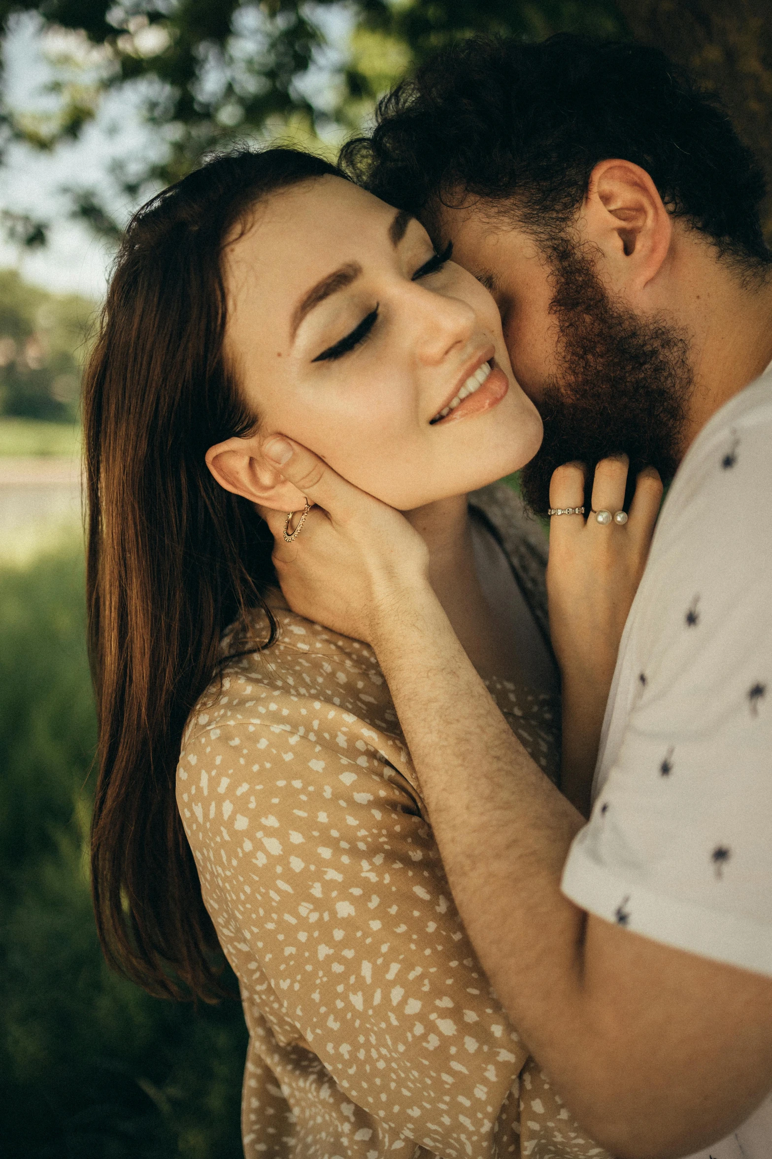 a man kissing a woman under a tree, trending on pexels, renaissance, hairy, brunette woman, two men hugging, closeup portrait