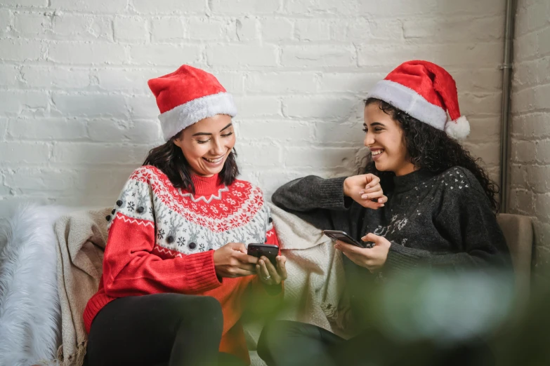 a couple of women sitting on top of a couch, pexels, wearing santa hat, avatar image, phone photo, profile image