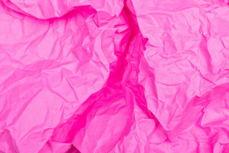 a woman laying on top of a bed covered in pink sheets, by Helen Stevenson, visual art, paper crumpled texture, fluorescent colours, closeup, fuchsia