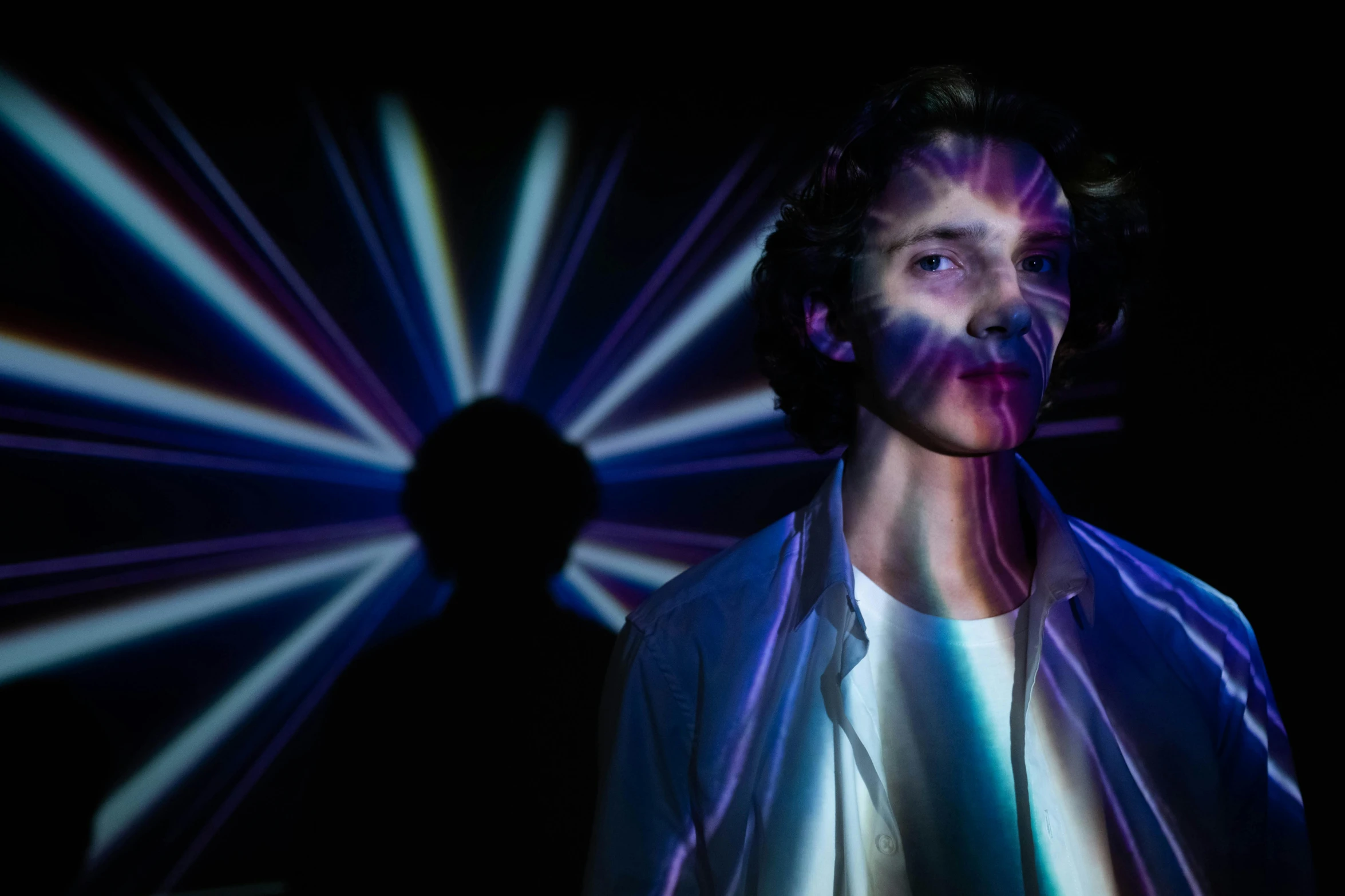 a man that is standing in front of a light, by Adam Marczyński, holography, eleven/millie bobbie brown, unreal engine : : rave makeup, robert sheehan, colour photograph