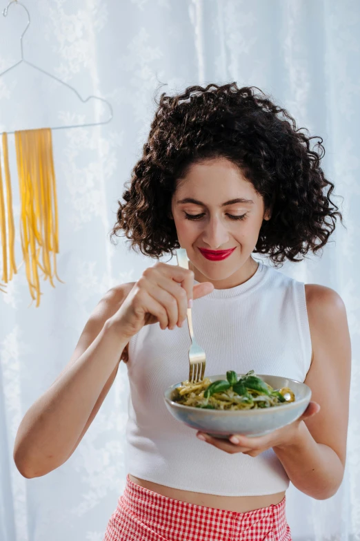 a woman eating a bowl of pasta with a fork, inspired by Josefina Tanganelli Plana, healthy, glowing, basil, promotional image