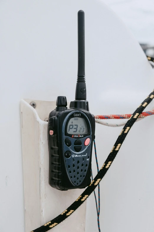 a close up of a walkie talkie attached to a wall, boat, connectivity, cdx, navy