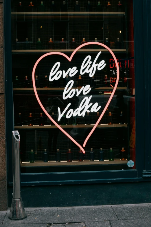 a neon sign that says love life love vodka, inspired by Nan Goldin, pexels, graffiti, window, whisky, sephora, snacks