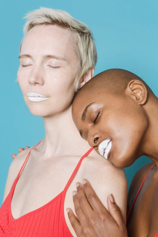 a couple of women standing next to each other, inspired by Bert Stern, trending on pexels, antipodeans, white face paint, bald, lesbian kiss, photoshoot for skincare brand