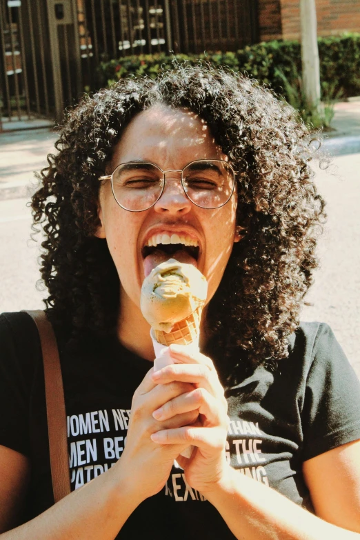 a woman is eating an ice cream cone, by Winona Nelson, pexels contest winner, renaissance, dark short curly hair smiling, alexandria ocasio cortez, 🐿🍸🍋, college