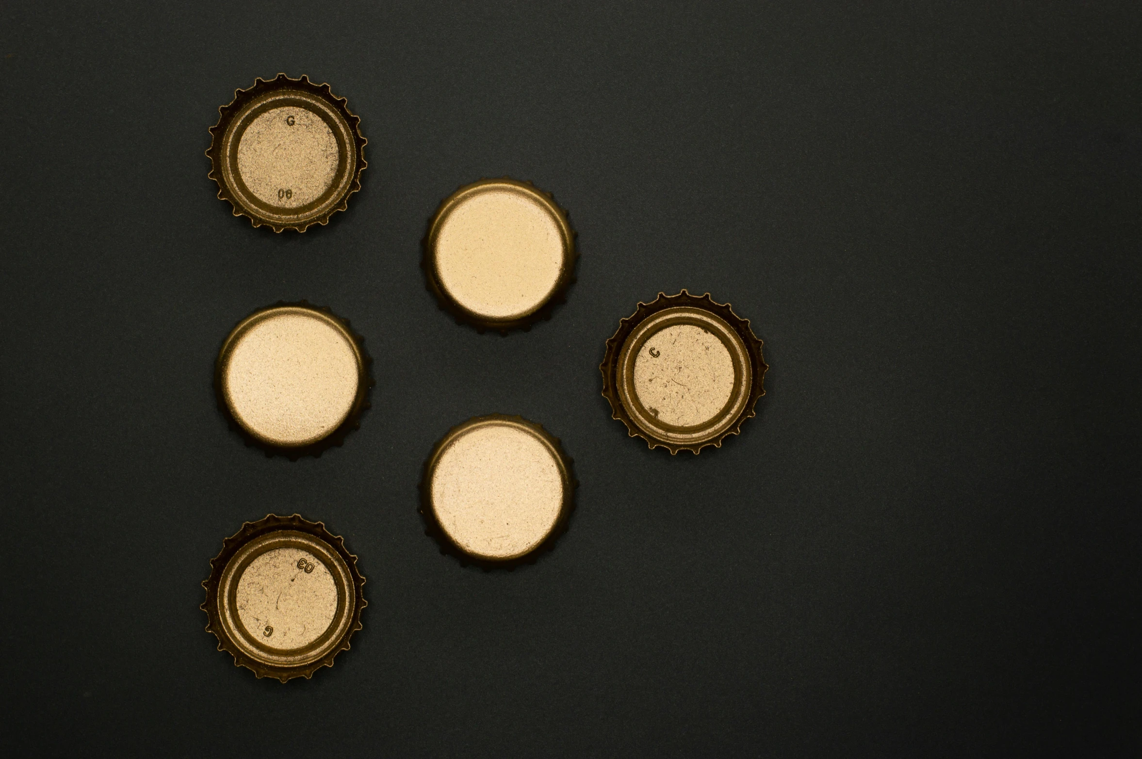 a group of beer bottles sitting on top of a table, by Zoltán Joó, pexels contest winner, visual art, gold gilded circle halo, knolling, panel of black, minimalist photo