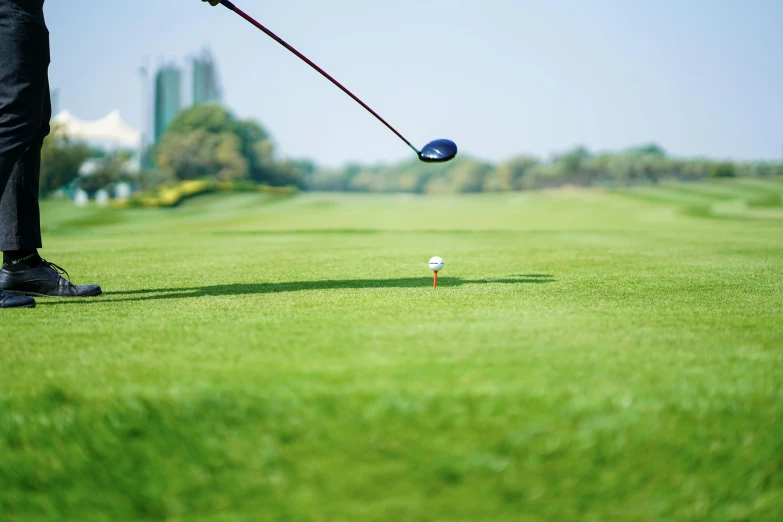 a man swinging a golf club at a golf ball, unsplash, realism, rectangle, lawns, colour photograph, gold