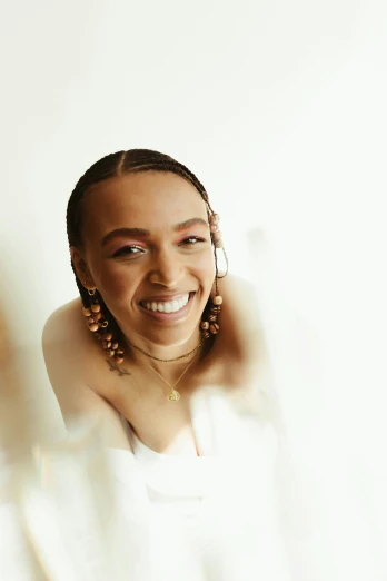 a woman posing for a picture in front of a mirror, an album cover, by Olivia Peguero, trending on pexels, earing a shirt laughing, cornrows braids, sydney sweeney, on clear background