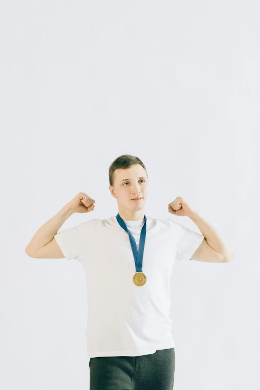 a man with a medal around his neck, pexels contest winner, muscular! white, linus from linustechtips, professional profile photo, male teenager