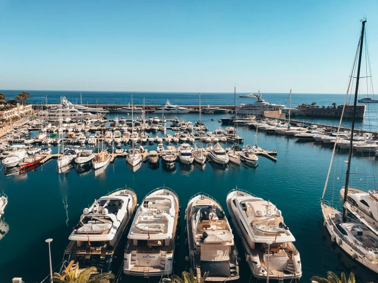 a marina filled with lots of white boats, a cartoon, pexels contest winner, happening, 💋 💄 👠 👗, views to the ocean, shaped like a yacht, beautiful daylight