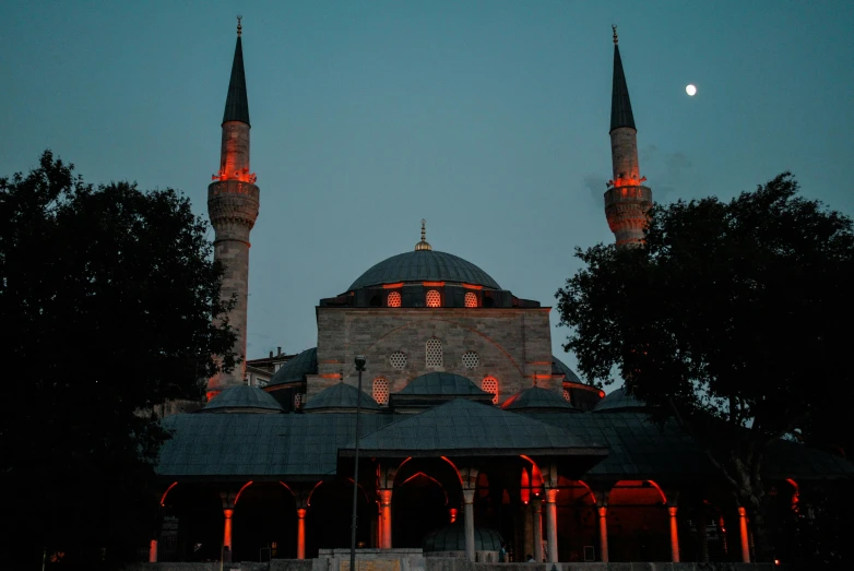 a mosque lit up at night with the moon in the sky, an album cover, pexels contest winner, hurufiyya, light red and deep blue mood, ottoman sultan, 256x256, grey