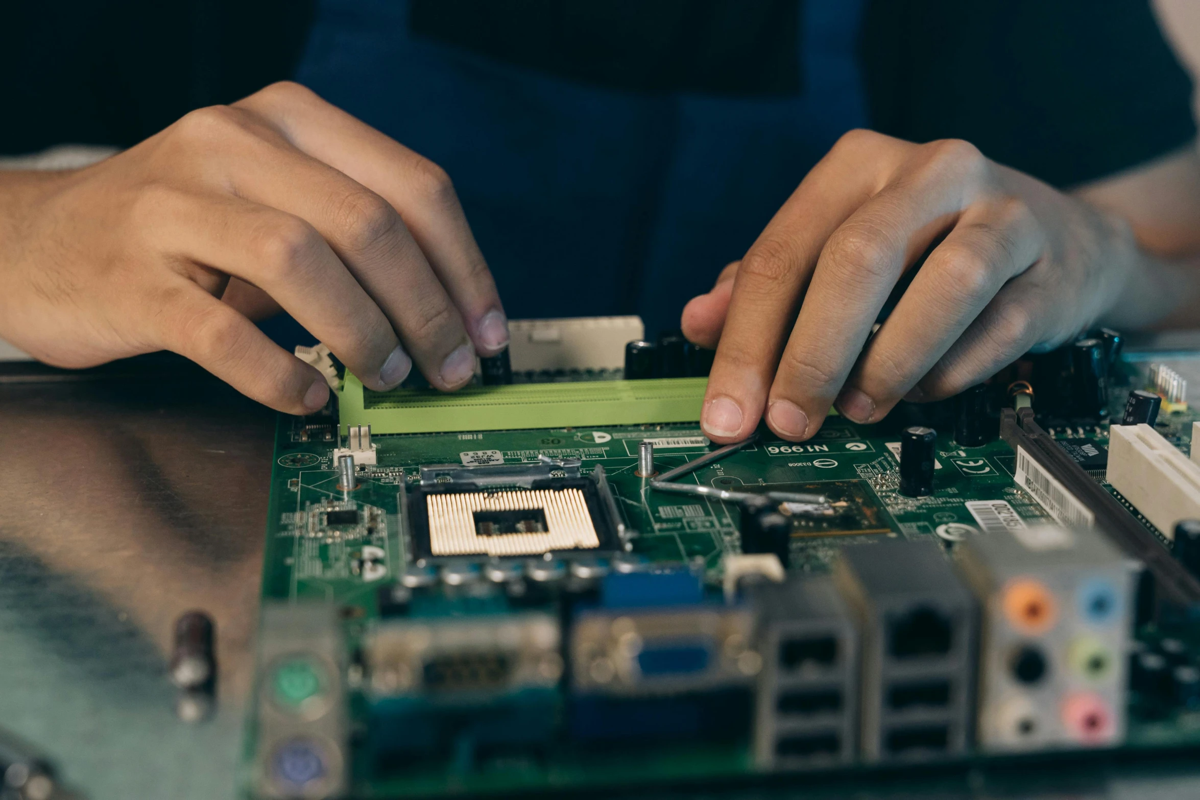 a close up of a person working on a motherboard, a computer rendering, pexels, renaissance, avatar image, green, getty images, educational