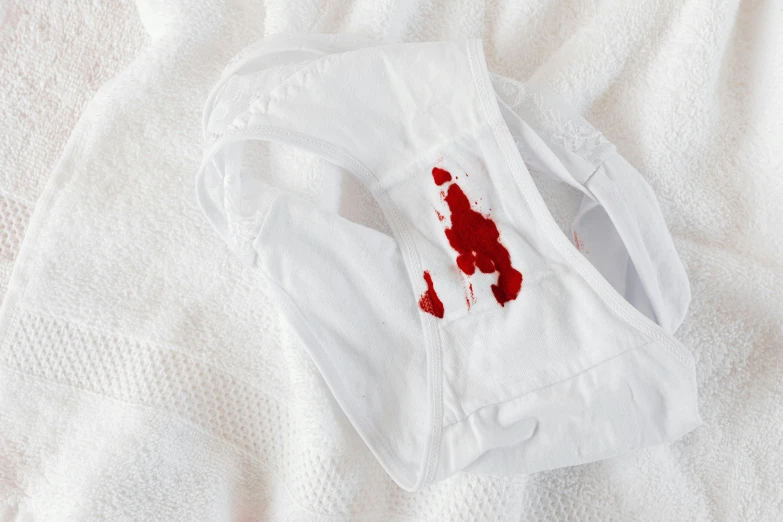 a white shirt with blood on it laying on a bed, by Matija Jama, pexels contest winner, facemask, bib bang, white finish, white