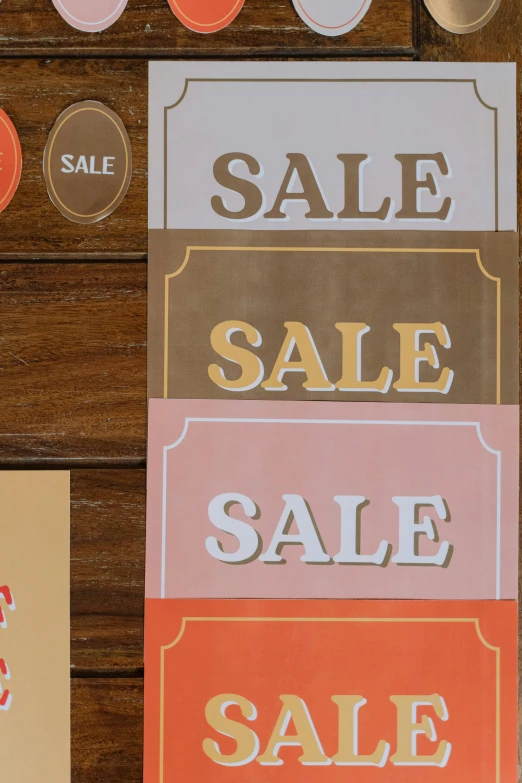 a bunch of signs sitting on top of a wooden table, poster art, by Jessie Algie, trending on unsplash, sales, orange safety labels, mall, 3 - piece