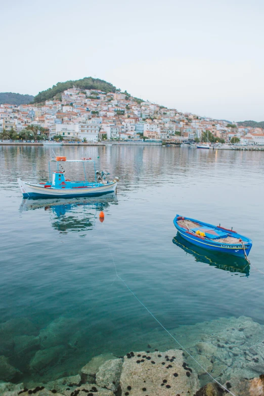 a couple of boats floating on top of a body of water, by Matija Jama, pexels contest winner, hydra, square, serene colors, overview