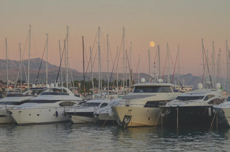 a number of boats in a body of water, by Carlo Martini, pexels contest winner, big moon in background, on a super yacht, harbour, thumbnail