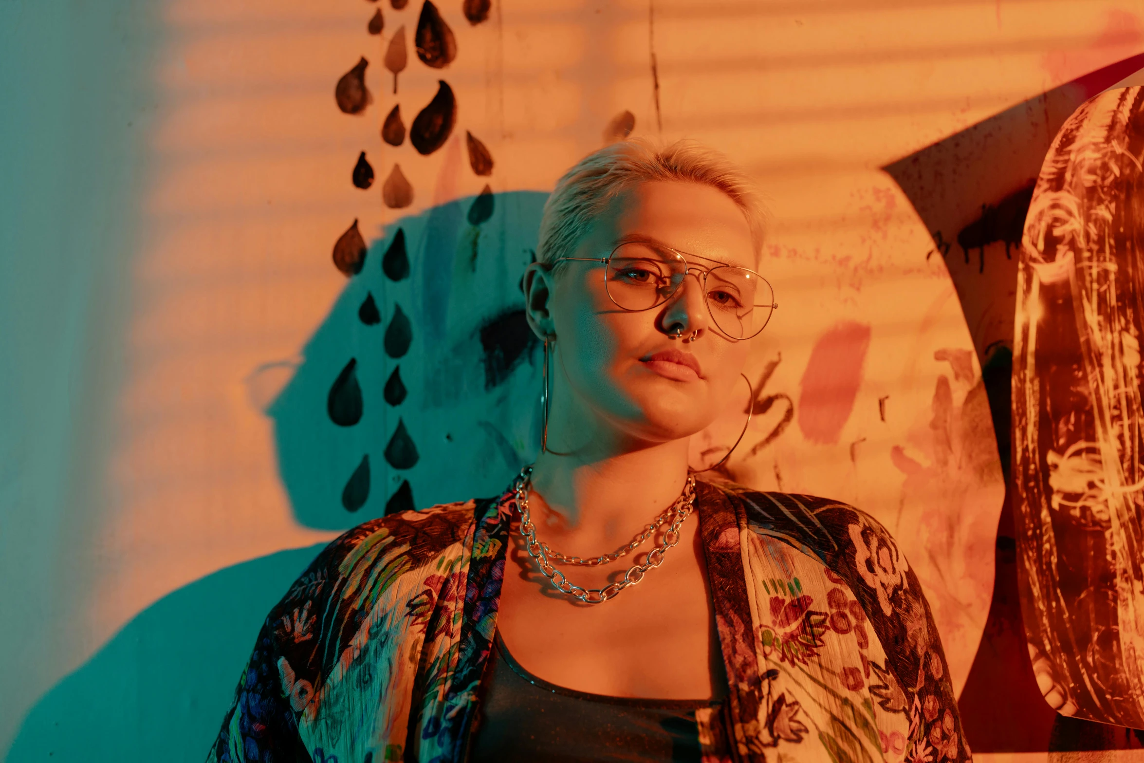 a woman standing in front of a wall holding an umbrella, an album cover, inspired by Elsa Bleda, trending on pexels, maximalism, thick glasses, color photograph portrait 4k, portrait of kim petras, standing in a dimly lit room