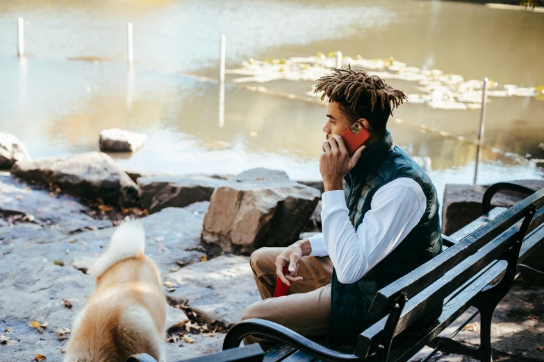 a man sitting on a bench talking on a cell phone next to a dog, trending on unsplash, visual art, portrait of willow smith, central park, 15081959 21121991 01012000 4k, snacks