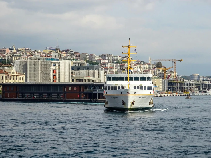 a large white boat floating on top of a body of water, by Edward Avedisian, pexels contest winner, hurufiyya, trams, ottoman empire, terminal, thumbnail