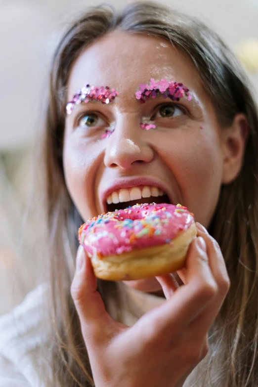 a woman eating a donut with sprinkles on her eyes, a portrait, trending on pexels, made of glazed, glitter gif, adafruit, pink