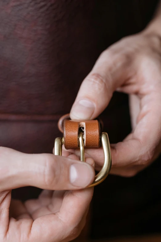 a close up of a person holding a belt, a picture, detailed product image, saddle up, monocle, 3 / 4 wide shot