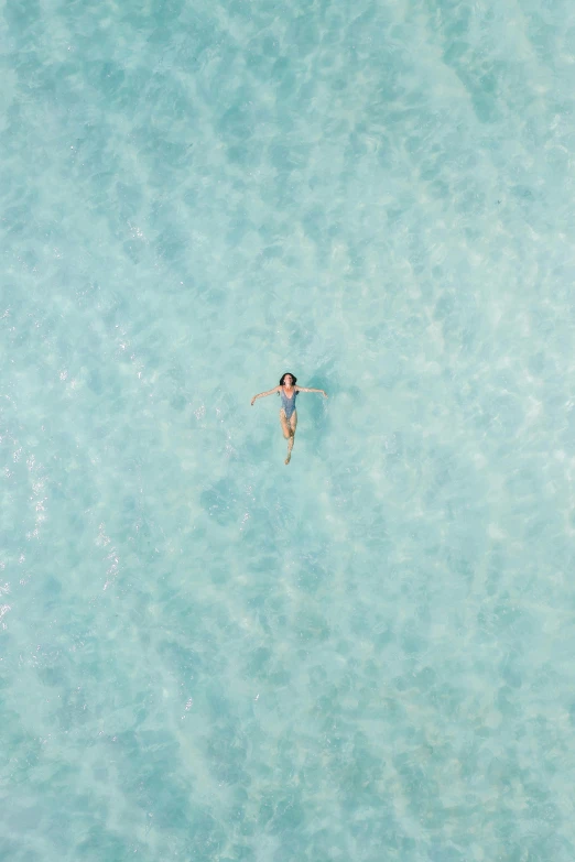 a person swimming in a body of water, by Tobias Stimmer, unsplash contest winner, minimalism, gold coast australia, 4k/8k, birdseye view, female floating