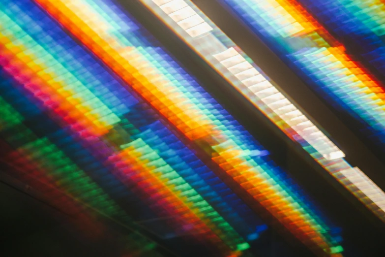 a close up of a rainbow colored light, a microscopic photo, inspired by Gabriel Dawe, unsplash, holography, vhs glitch, panels, reflective scales, vhs colour photography