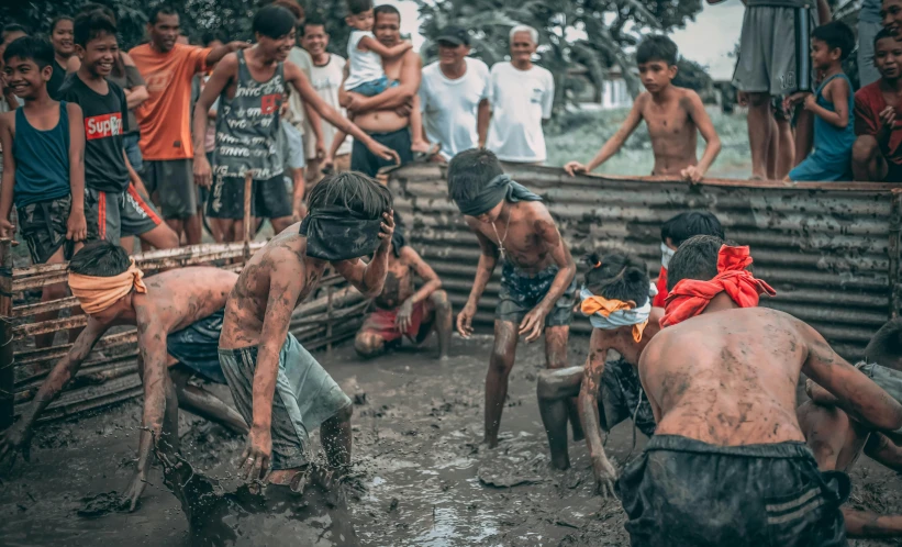 a group of people playing in the mud, a colorized photo, pexels contest winner, philippines, rotting black clay skin, getting ready to fight, instagram story