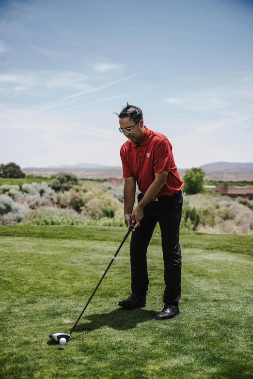 a man in a red shirt is playing golf, by Robbie Trevino, rafeal albuquerque, damien tran, profile picture, sweeping vista