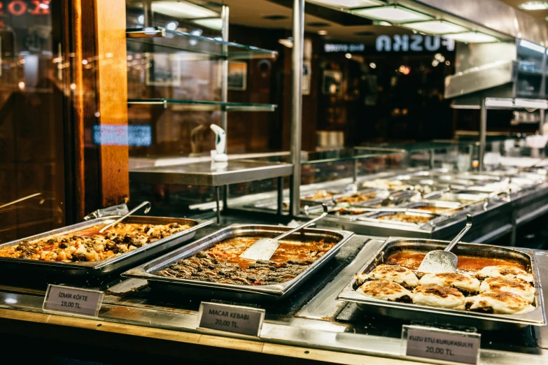 a buffet filled with lots of different types of food, a photo, by Julia Pishtar, unsplash, mingei, manly, bakery, exterior shot, taken in the 2000s