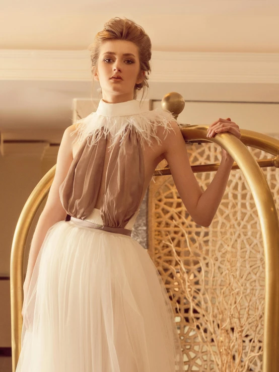 a woman standing next to a chair in a room, an album cover, by Emma Andijewska, renaissance, modern stylish glamour tutu, white halter top, ethereal macaw, brown ) )