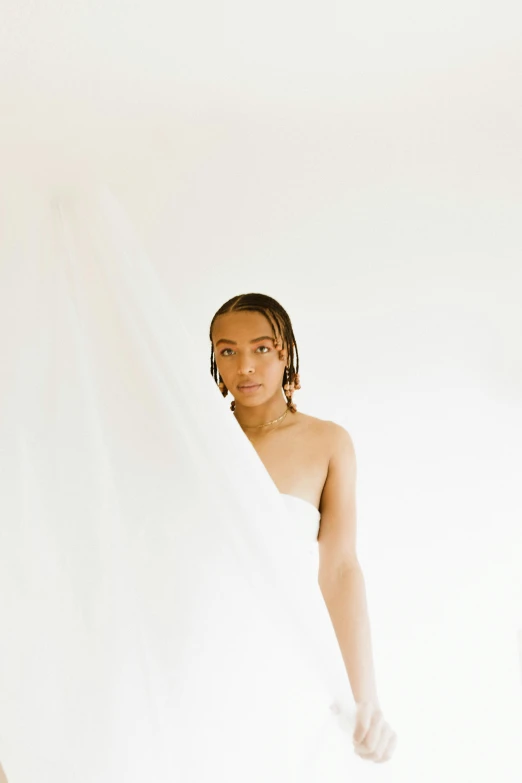 a woman standing in front of a white curtain, light brown skin, showers, off - white collection, tyler