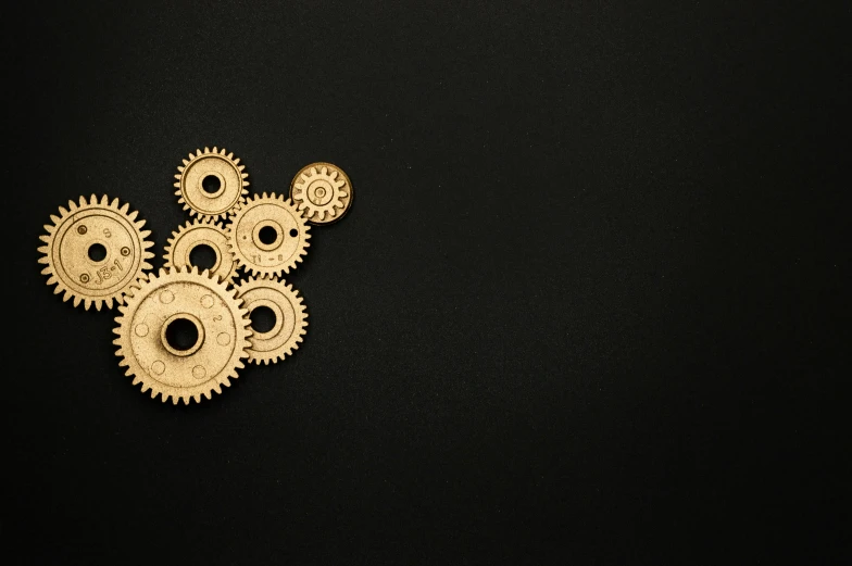 a bunch of gears sitting on top of a black surface, pexels contest winner, kinetic art, gold decorations, but minimalist, steampank style, thumbnail