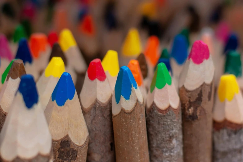 a close up of a bunch of colored pencils, a child's drawing, by David Simpson, trending on pexels, brown, diversity, thumbnail, a wooden