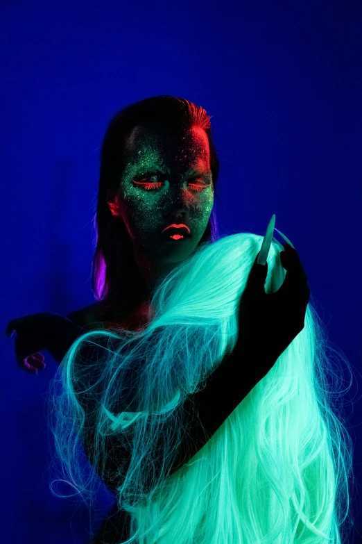 a woman with long white hair and green makeup, inspired by Elsa Bleda, pexels contest winner, conceptual art, red and blue neon, glowing guy creature, she has a glow coming from her, uv blacklight