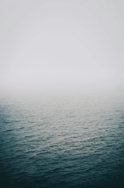 a large body of water in the middle of a foggy sky, a picture, inspired by Elsa Bleda, unsplash, minimalism, 2 5 6 x 2 5 6 pixels, low quality photo, shot on sony a 7, the sea of sadness