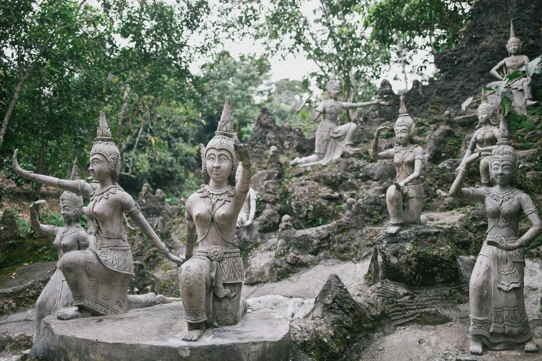 a group of statues sitting on top of a rock, in a jungle, bangkok, fan favorite, film photo