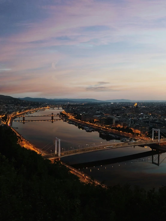 a view of a bridge over a body of water, by Adam Szentpétery, pexels contest winner, vista of a city at sunset, austro - hungarian, 4 k cinematic panoramic view, very high view