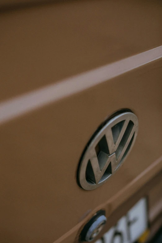 a close up of a volkswagen logo on a vehicle, unsplash, brown body, 2010s, perfect photo, 35mm color photo