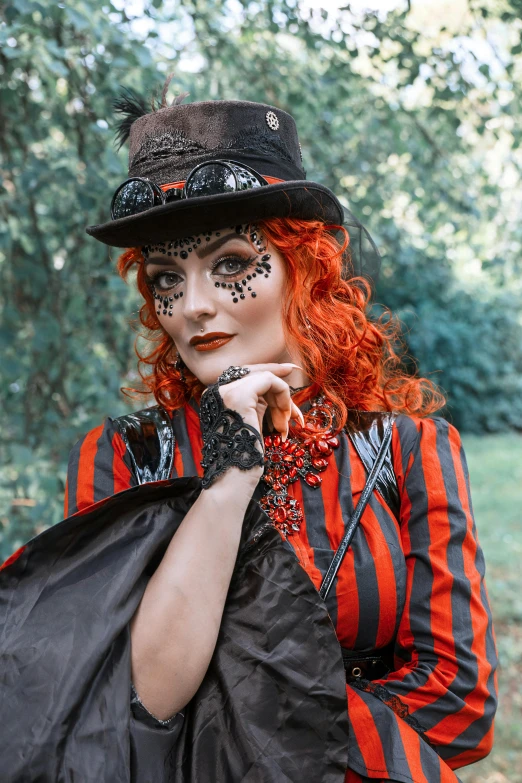 a woman dressed in a red and black outfit, a portrait, inspired by Louis Grell, pexels contest winner, chitty chitty bang bang, ( redhead, the mad hatter, trick or treat