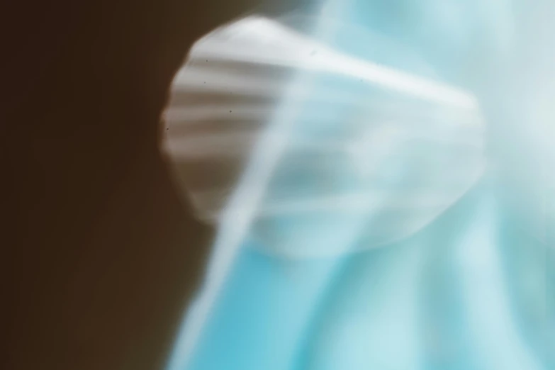 a close up of a toothbrush with a blurry background, a macro photograph, inspired by Agnes Lawrence Pelton, holography, light blue dress portrait, motion lines, 35mm —w 1920 —h 1080, translucent wings